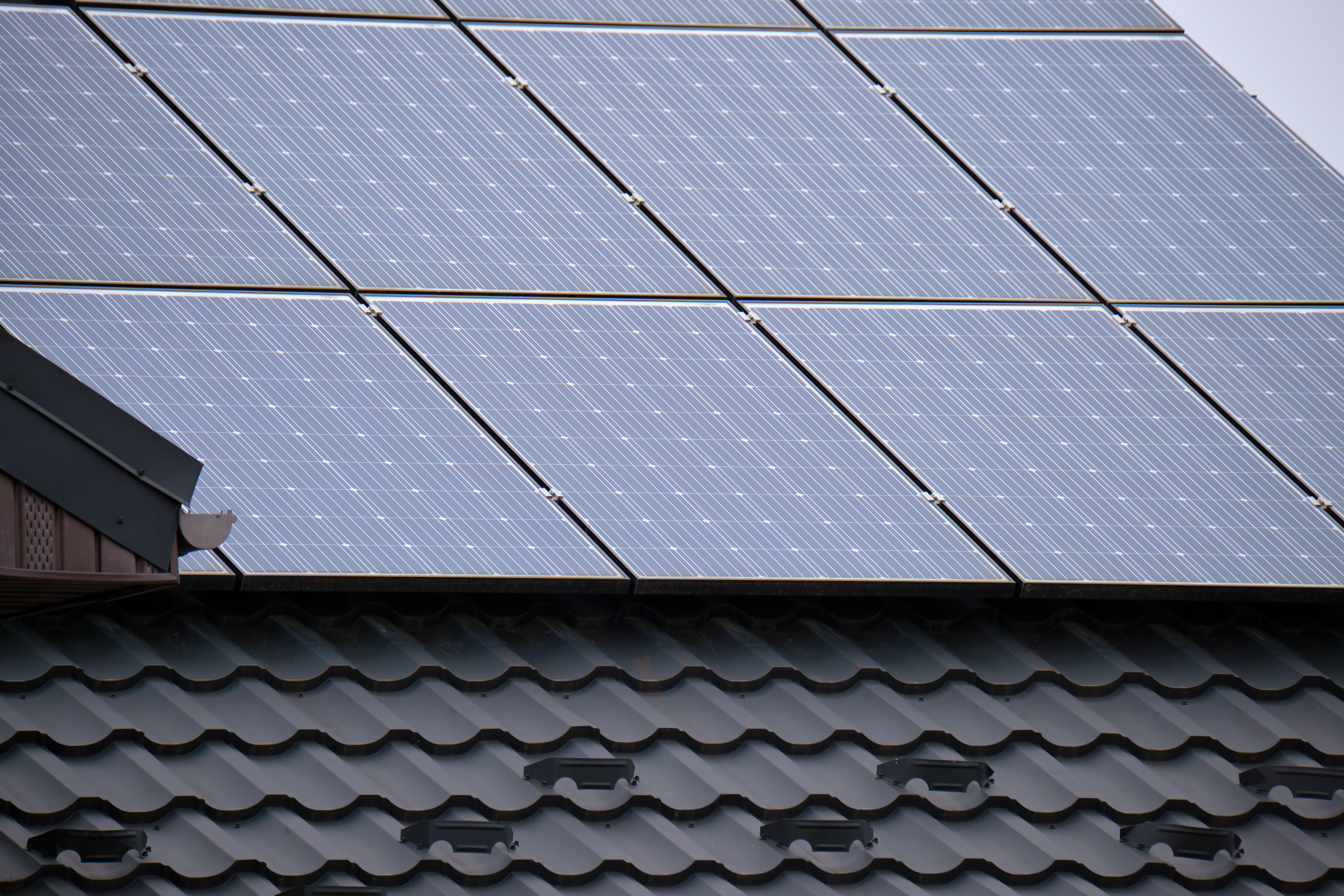 Solar panels installed on a tiled roof, showcasing renewable energy integration in residential construction.